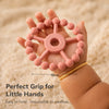 Cubkins Ring Teether in Raspberry held in an adult palm showing 10cm diameter – perfect grip size for babies, easy to hold and impossible to swallow
